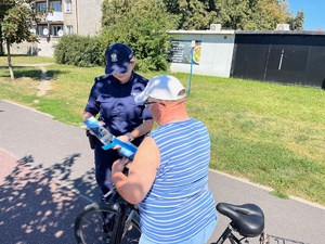 policjantka stojąca obok rowerzysty